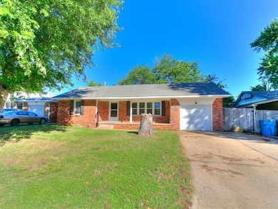 Single story home with an attached garage, concrete driveway, and brick siding