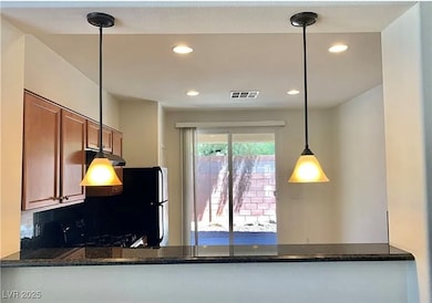 Kitchen with dark stone countertops, decorative li