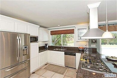 Kitchen overlooks pool and patio