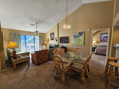 Carpeted dining area with high vaulted ceiling, ce