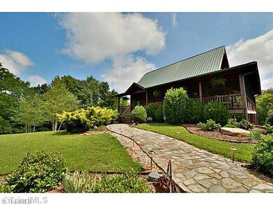 Exterior Front. Stone walkway and decorative lighting enhances the meticulous landscaping that leads to the front door.