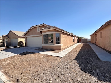 View of front facade with a garage, driveway, a ti