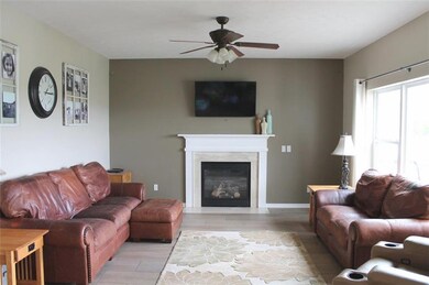 Living room with new flooring, gas fireplace and e