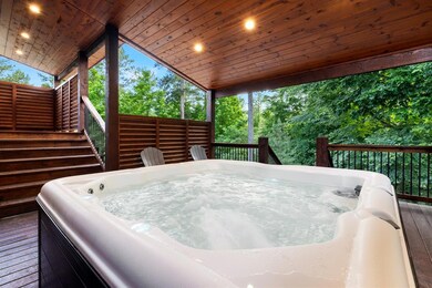 Wooden deck with a hot tub and stairway