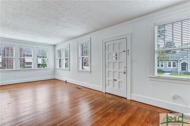 The living room has many windows that bring in ple