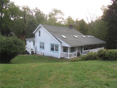 Large covered porch with doors to Kitchen.