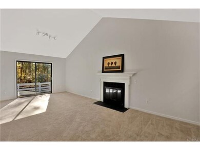 Huge great room with new carpet, cathedral ceiling