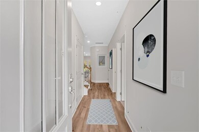 Hallway with recessed lighting, stairway, light wood-style floors, and baseboards