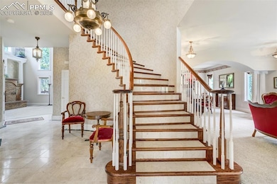 Sweeping curved staircase in marble and wood