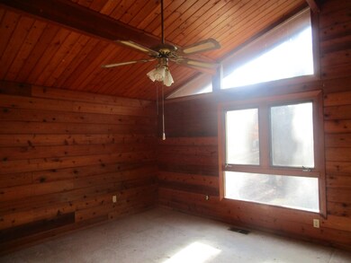 Unfurnished room featuring vaulted ceiling with be