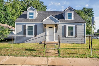 New england style home featuring a gate and a fenced front yard