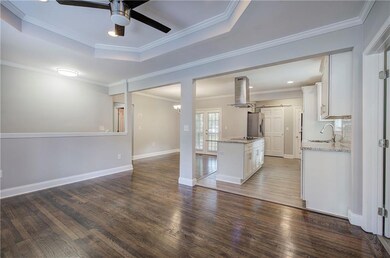 Kitchen featuring white cabinets, dark hardwood / 