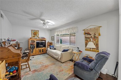 Living room featuring a textured ceiling, visible