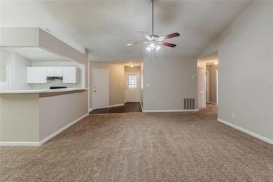 Unfurnished living room featuring dark colored car