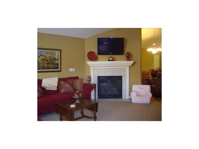 Spacious living room has vaulted ceiling and firep