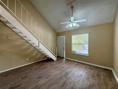 Unfurnished living room featuring baseboards, woo