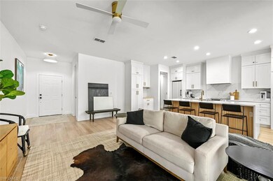Living area featuring light wood-type flooring, recessed lighting, a ceiling fan, and baseboards