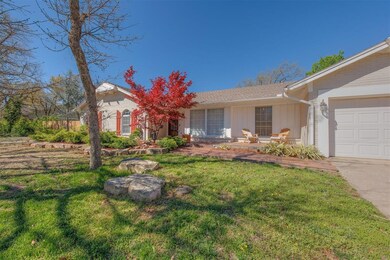 Ranch-style house with a garage and a front lawn
