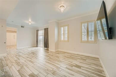 Living Room with ornamental molding and light wood finished floors