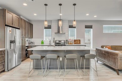 Kitchen featuring a breakfast bar, light countert