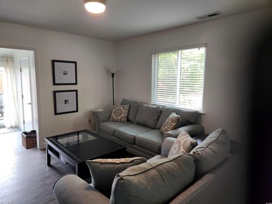 Living room with visible vents and wood finished f