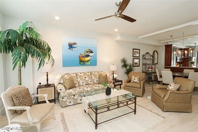 Living room with ceiling fan with notable chandeli