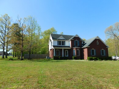 Beautiful front yard surrounded by woods.