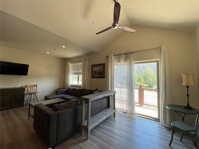 Living room featuring vaulted ceiling, hardwood /