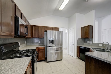 Kitchen includes fridge, dishwasher and gas range