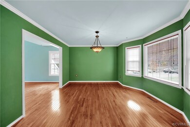 Spare room with ornamental molding and hardwood /