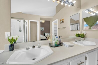 Ensuite bathroom featuring double vanity, a stall