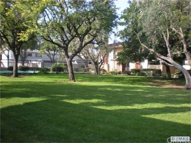 Front exterior with greenbelt and pool