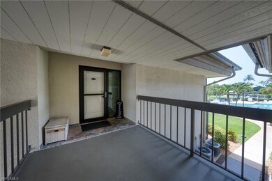 View of exterior entry featuring a balcony and stucco siding