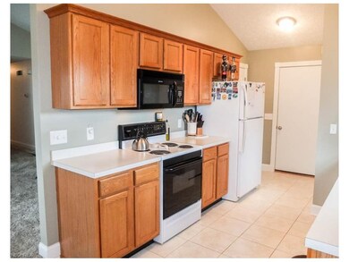Kitchen has grouted vinyl tile floors.