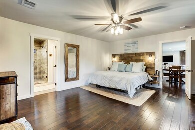 Bedroom with baseboards, ensuite bathroom, a ceil