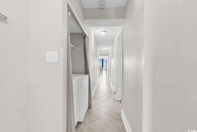 Hall with light tile patterned floors