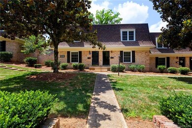 Mature landscaping frames the entrance.