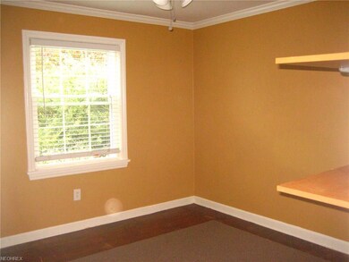 Bedroom down with hardwood floors
