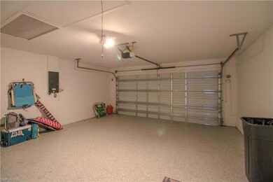 Garage with electric panel and a garage door opene