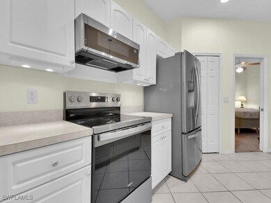 Kitchen with stainless steel appliances, white cab