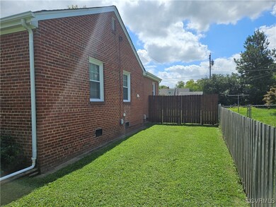 View of side of home with a lawn
