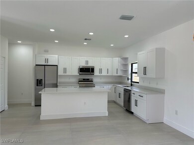 Kitchen featuring open shelves, appliances with st