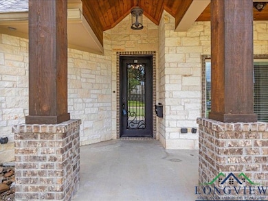 View of exterior entry featuring stone siding