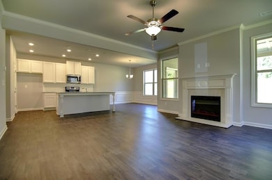 Unfurnished living room with ceiling fan, a tile f