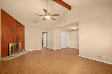 Unfurnished living room with a ceiling fan, wood 