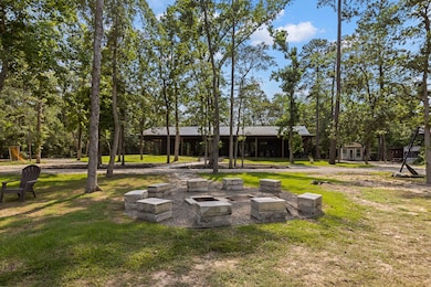 Surrounded by trees, this rustic fire pit area inc