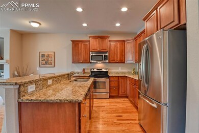 Kitchen with beautiful hardwood floors, granite co