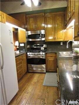 Kitchen with hardwood flooring and granite counter