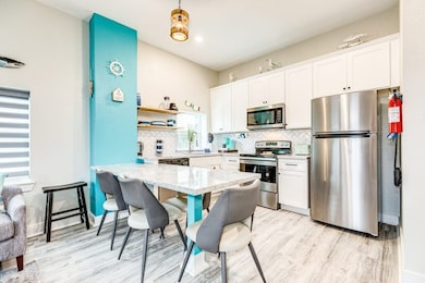 Kitchen area with stainless steel fridge and dishwasher