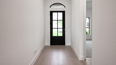 Entryway featuring a textured wall, wood finished